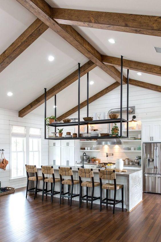 Wooden beams overhead evoke the traditional farmhouse kitchen aesthetic and warmth