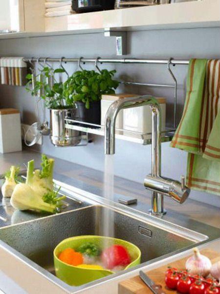 Hang dish towels on hooks to​ keep your galley kitchen organized