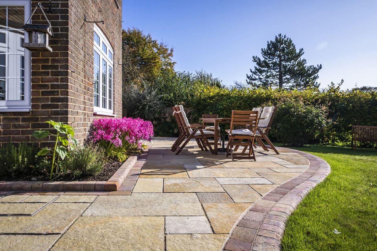 Use colorful paving stones to create unique patterns in your front yard landscaping