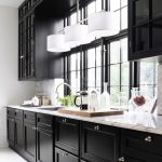 black kitchen cabinets natural light as balancing feature. RHSRQBZ