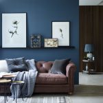 blue living room chic seating area with a brown sofa and a navy accent wall and CZXYWAJ
