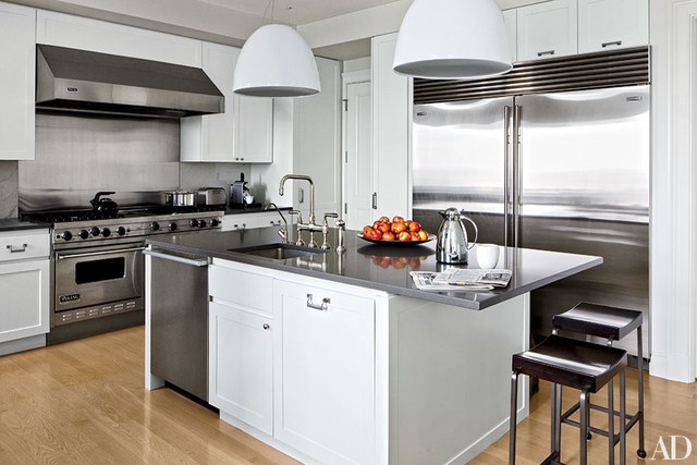 contemporary kitchens domed pendant lights by artemide hang above a caesarstone-topped island in  a XRWJFKY