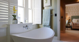 en suite bathroom white en-suite bathroom with green stripe wallpaper GDCJVPH