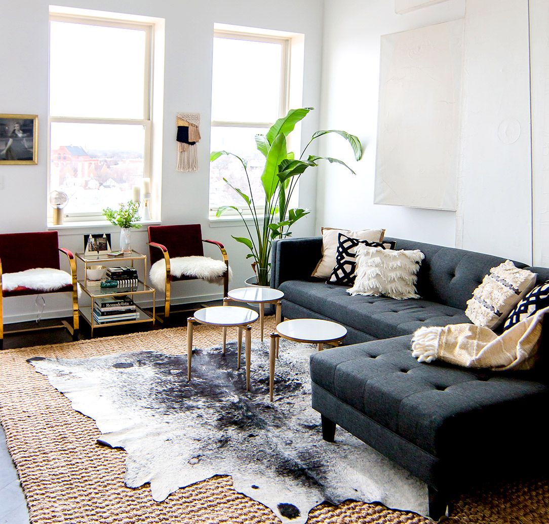 rug decor gray sofa with modern coffee tables, cowhide rug, and indoor plants. i love XLQRLSV