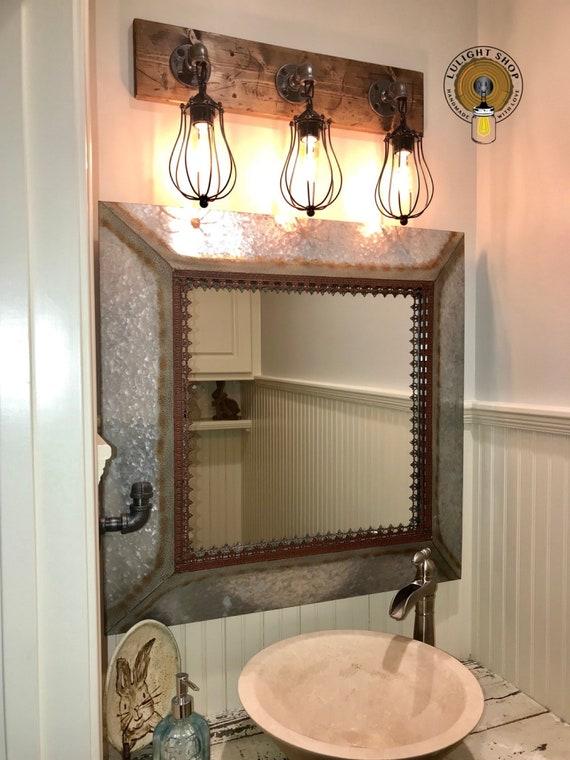 Farmhouse bathrooms ‌shine with vintage-inspired ​lighting fixtures