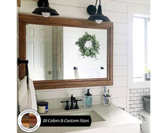 Rustic⁤ mirrors with ⁣wooden frames elevate farmhouse bathrooms elegance