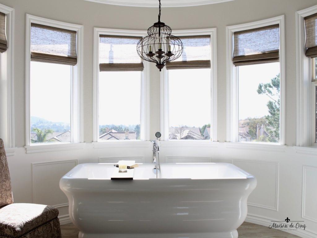 Freestanding tubs create a ​luxurious feel in farmhouse bathrooms