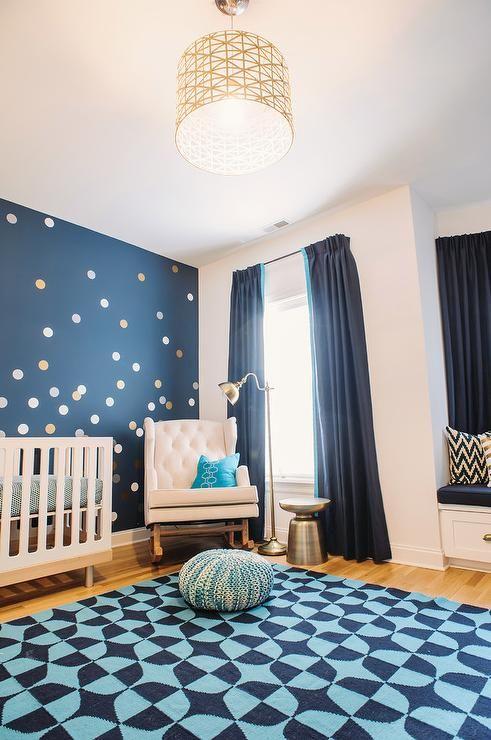 Bold navy blue accents add sophistication to a modern boy nursery