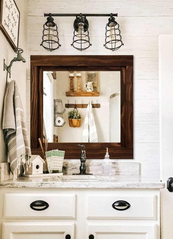 Hang a large, framed mirror⁣ to brighten farmhouse bathrooms