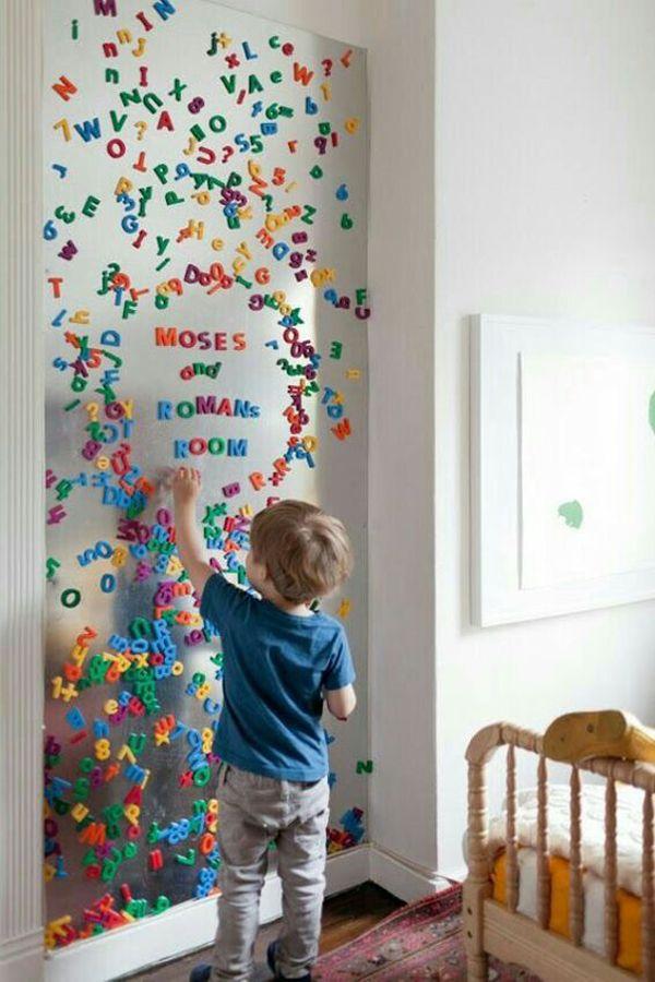 Interactive wall features encourage play in a boy nursery setting