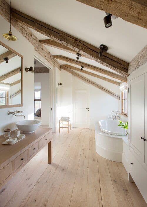 Exposed beams highlight the​ character of farmhouse bathrooms