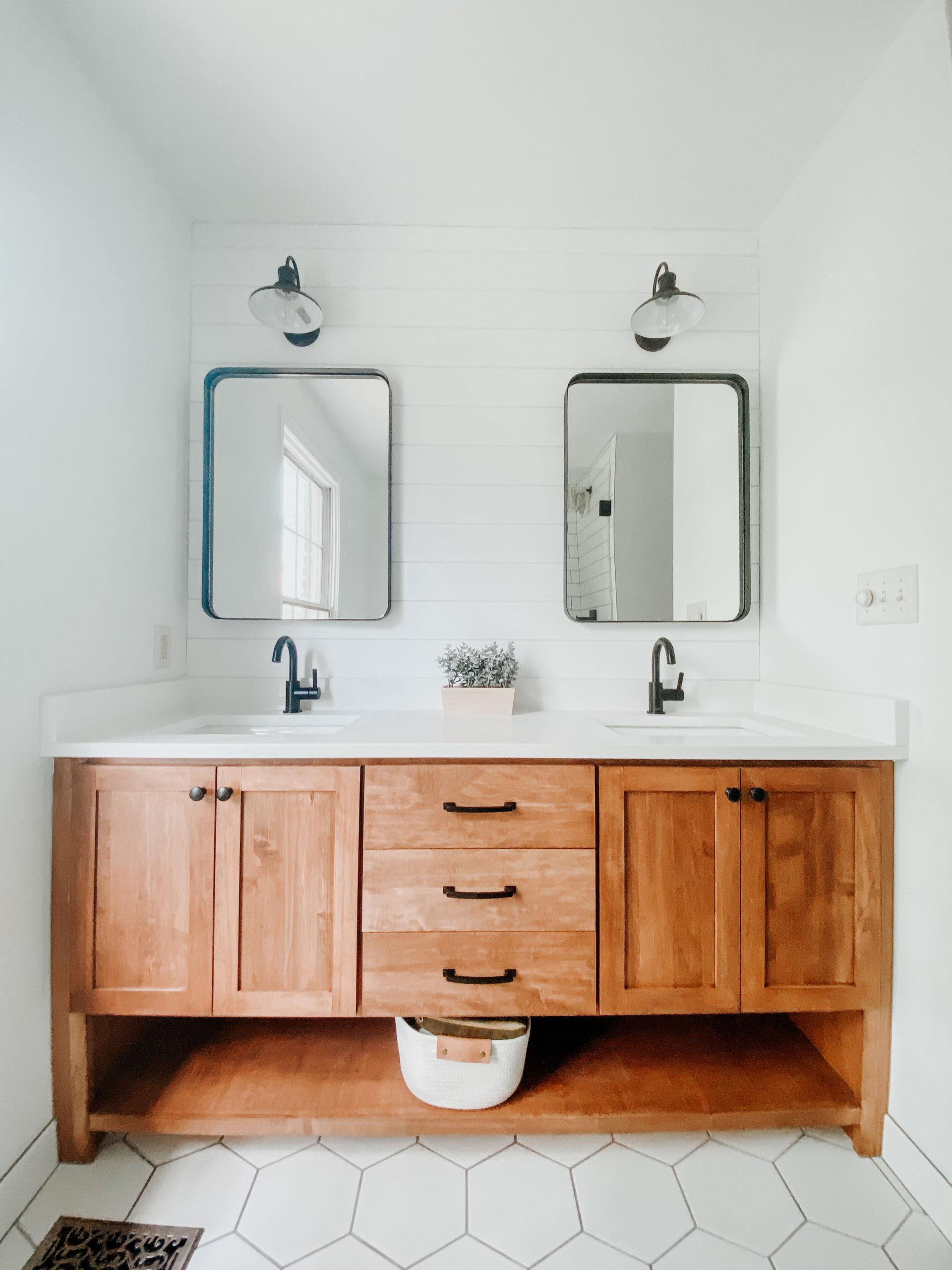 Incorporate natural wood elements for warmth in farmhouse bathrooms