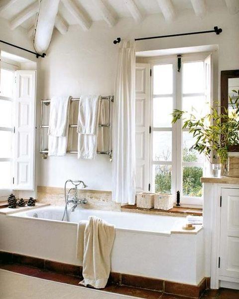 Farmhouse bathrooms featuring large windows invite natural light