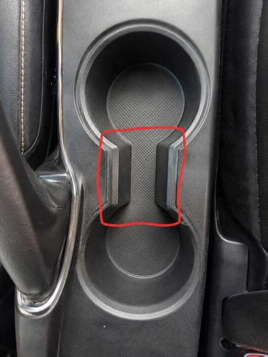The Hidden Purpose Behind That Small Gap Between Your Car Cup Holders