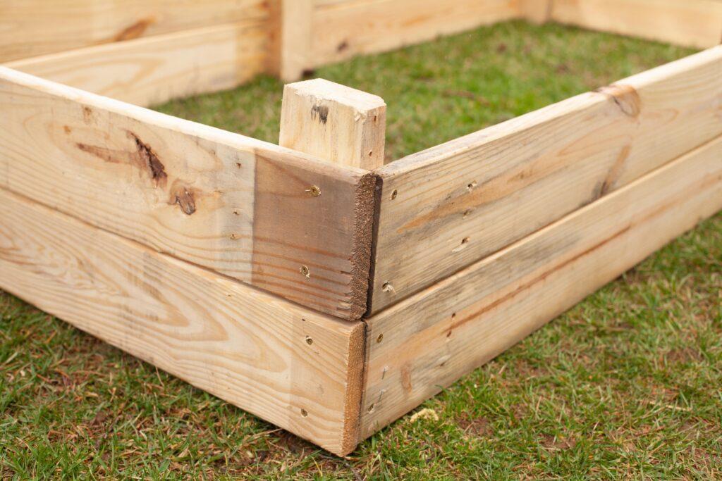 Craft a playful childrens corner using a raised Pallet Garden filled with veggies