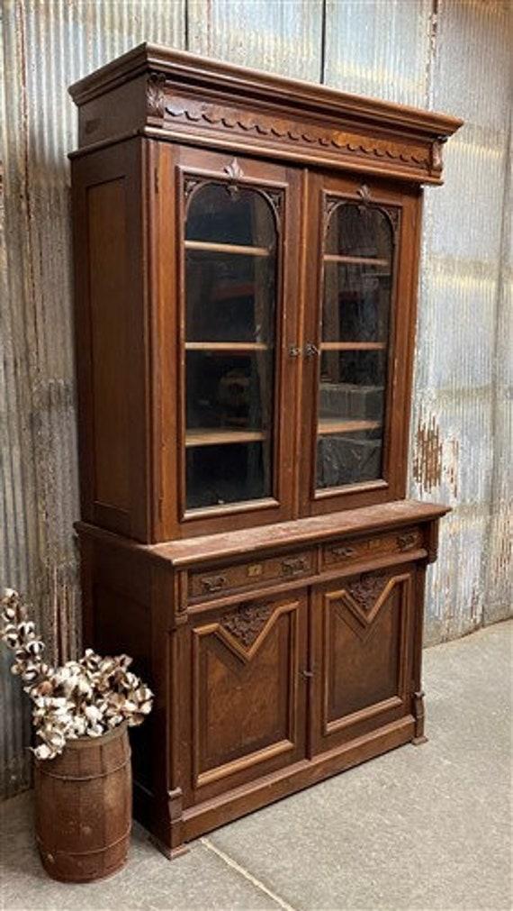 A vintage hutch showcases family heirlooms and cookware in your farmhouse kitchen