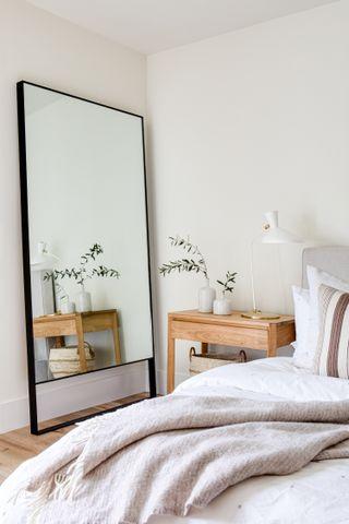 Use mirrors to ​create an illusion of space in your minimalist bedroom