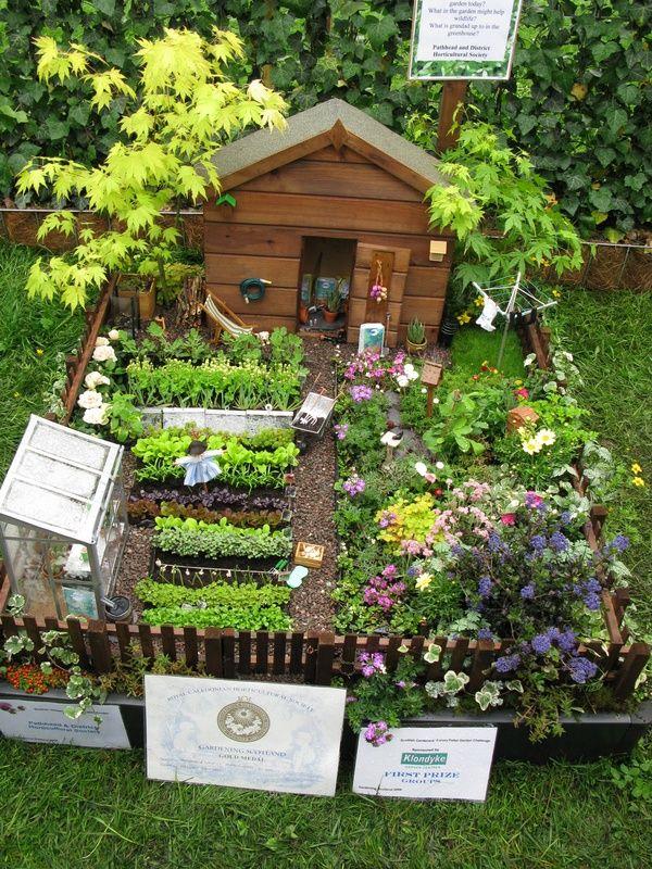 Create a whimsical fairy garden within a compact pallet garden setup