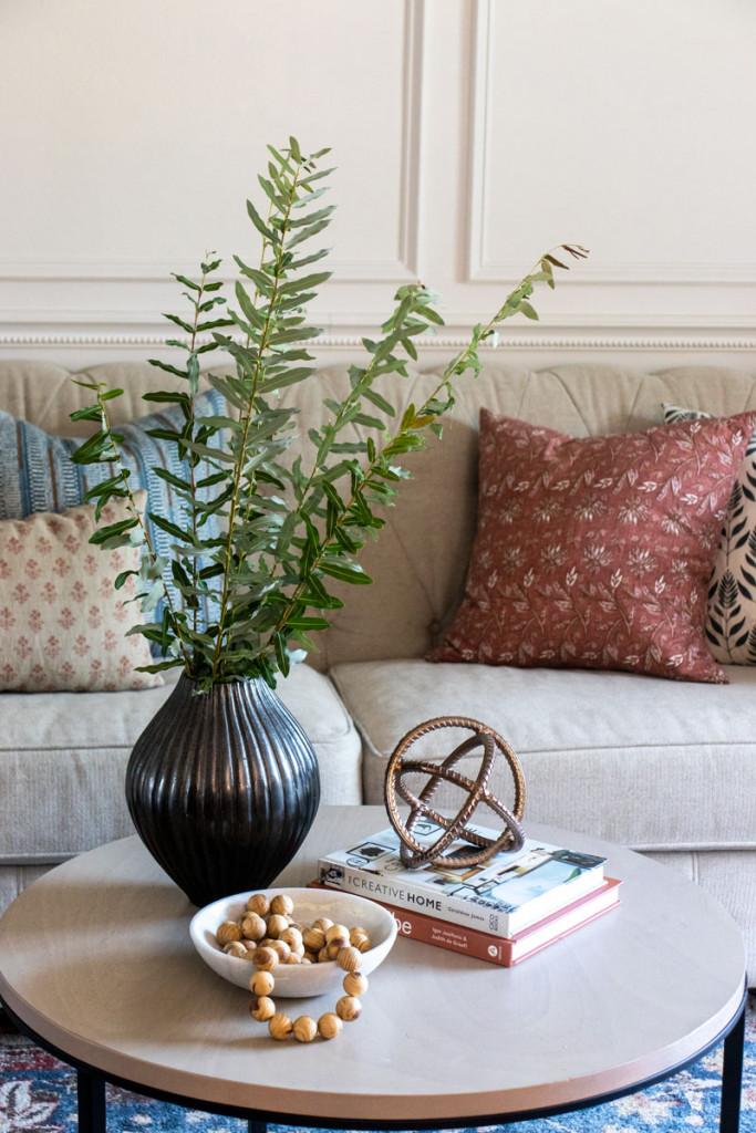 Curate a coffee table display for visual interest in your​ living room