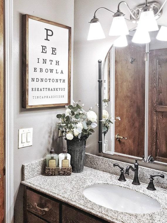 Farm-themed decor‍ provides a playful touch in farmhouse⁣ bathrooms