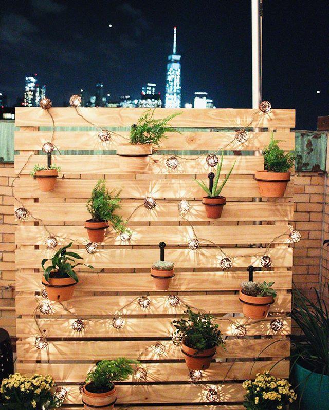 Incorporate string lights around your pallet garden‌ for an enchanting evening glow