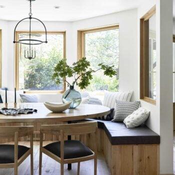 Create a cozy nook with a built-in bench and vibrant cushions in your eat-in kitchen