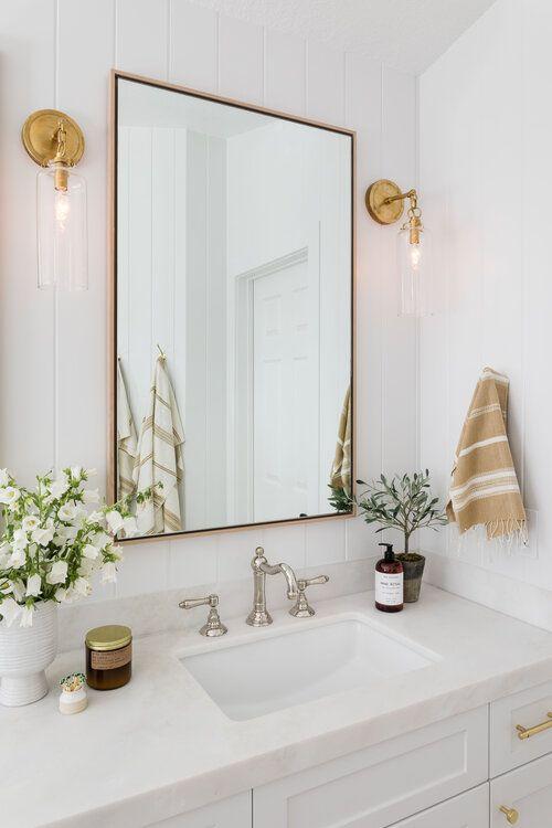 Mix metals in your lighting ​fixtures for an eclectic bathroom ⁢look