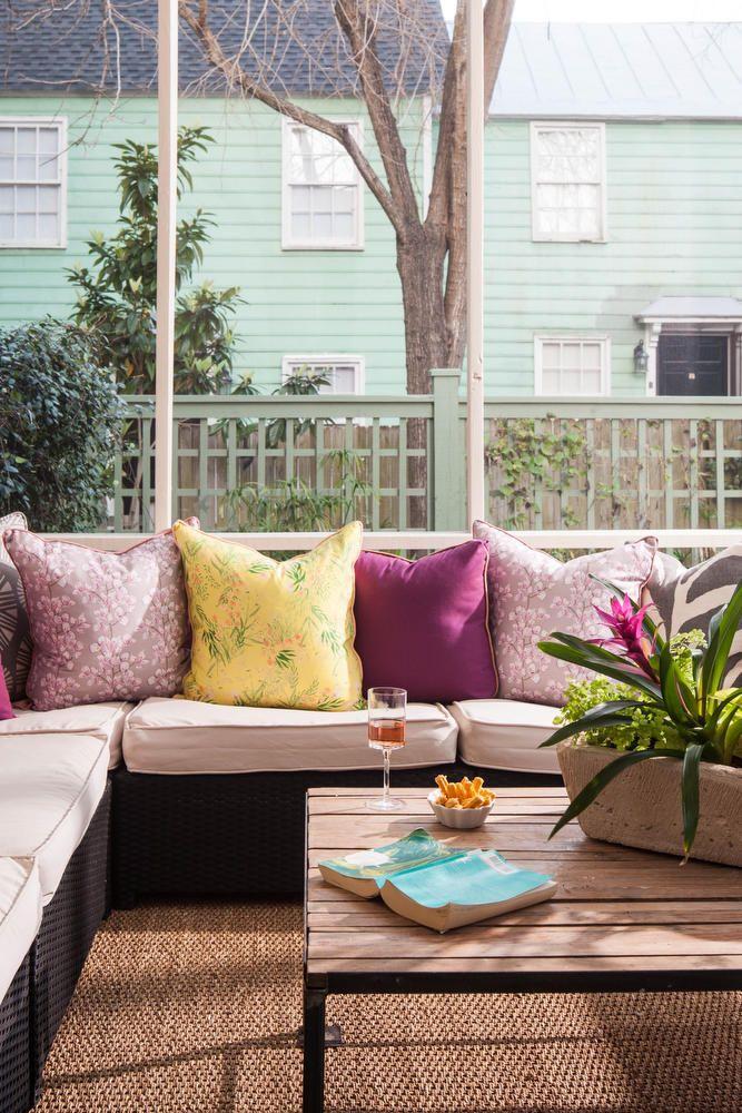 Use colorful throw pillows to bring personality to your screened porch seating ‍area