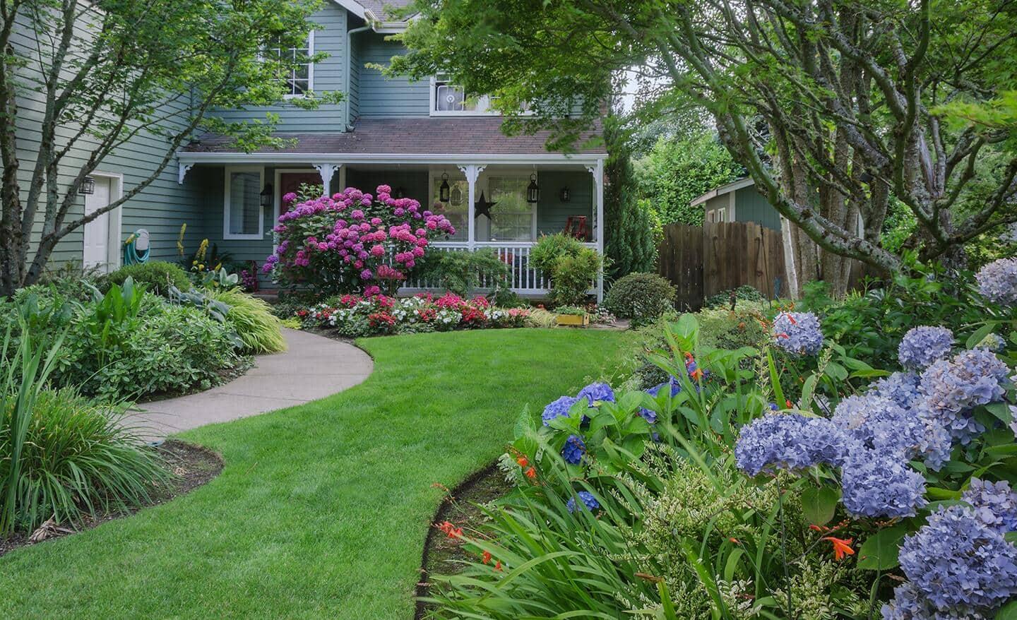 Embrace symmetry with a classic front yard landscaping design featuring matched plantings