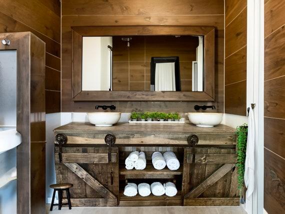 Barn ​doors as stylish space savers in farmhouse bathrooms