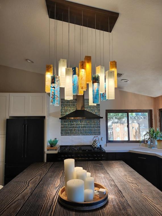 Artistic light fixtures in kitchens double as functional and decorative elements