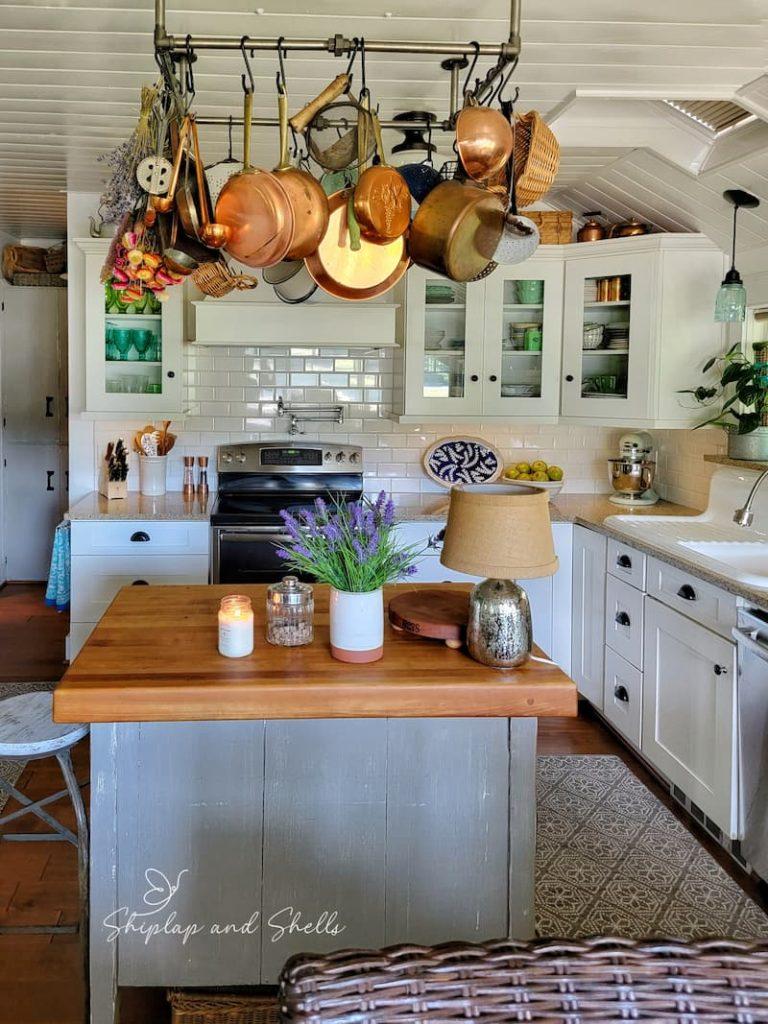 Hang pots and pans overhead‌ to free up counter space in your galley kitchen