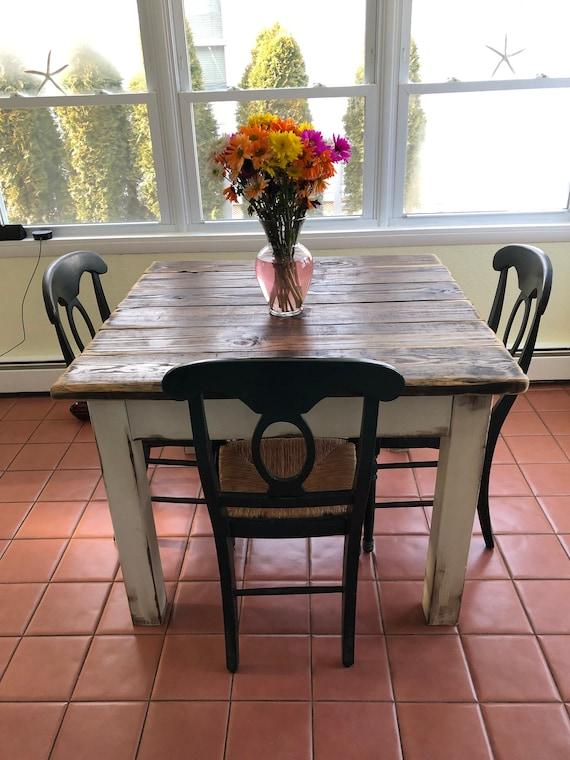 Distressed furniture pieces that contribute to the farmhouse kitchen’s rustic appeal