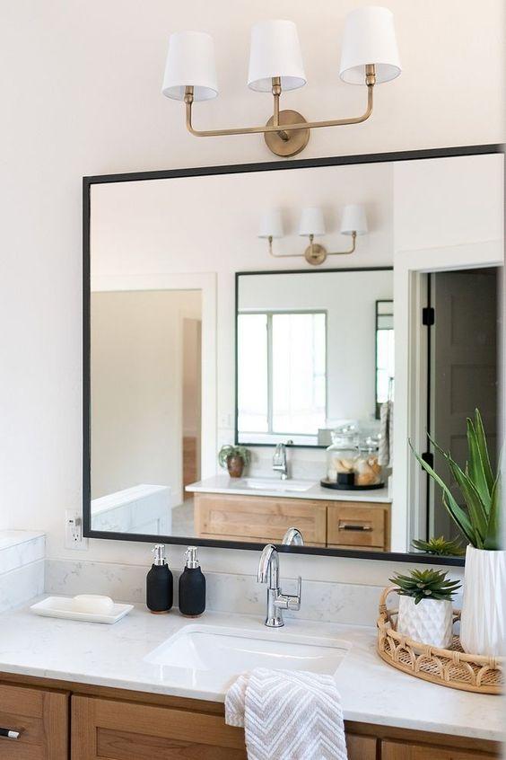 Use mirrored cabinets to enhance ​light in your narrow bathroom