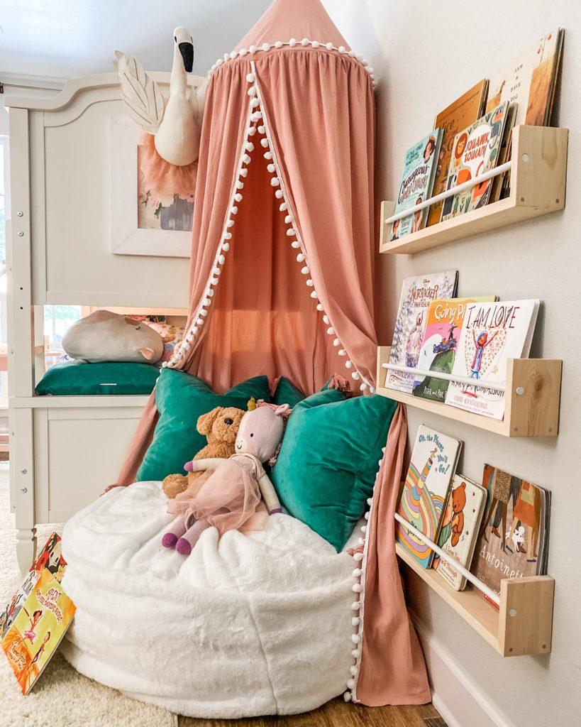 A cozy reading nook adds charm to any boy nursery design