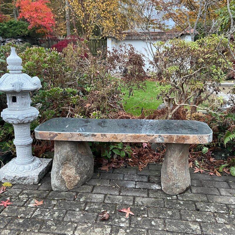 Stone benches offer rustic charm and restful spots in your Zen Garden