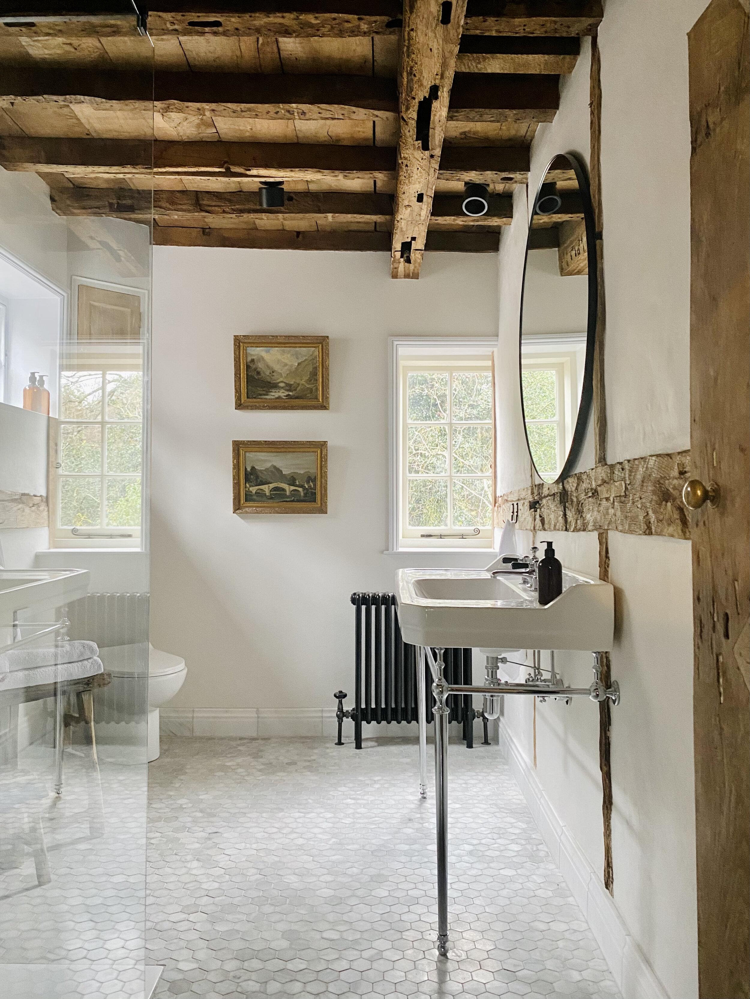 Rustic wood beams add warmth to ⁢farmhouse bathrooms