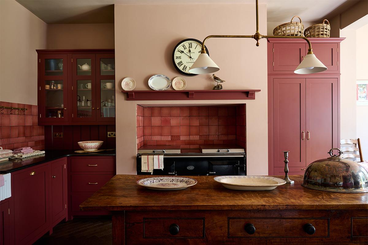 Consider a farmhouse sink to evoke warmth in your stylish burgundy kitchen