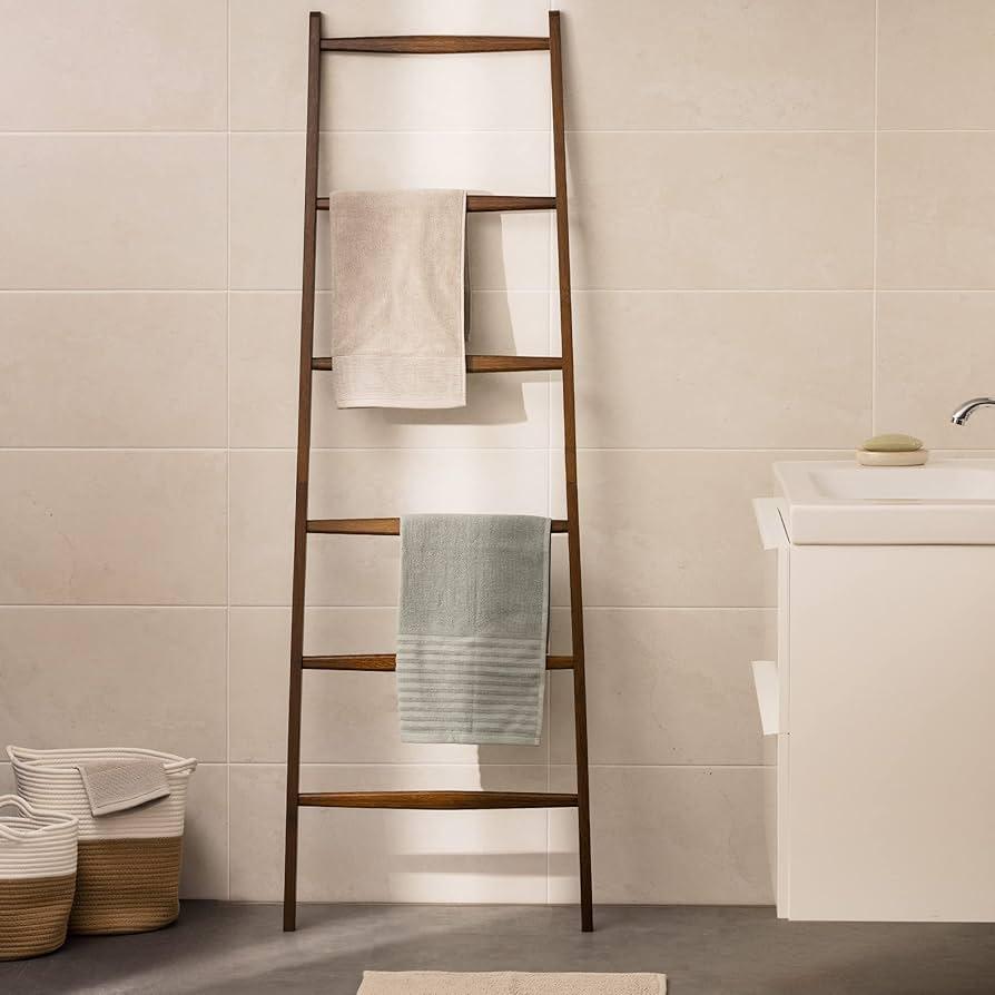 Hang a bathroom ladder for stylish towel storage ​in narrow bathrooms