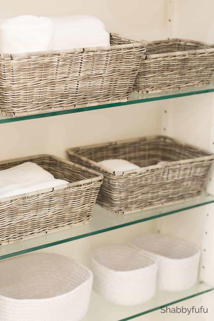 Use baskets to ​organize toiletries stylishly in narrow bathrooms