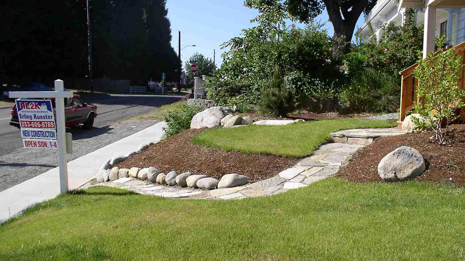 Create pathways using stones or pavers for a charming front yard landscaping touch