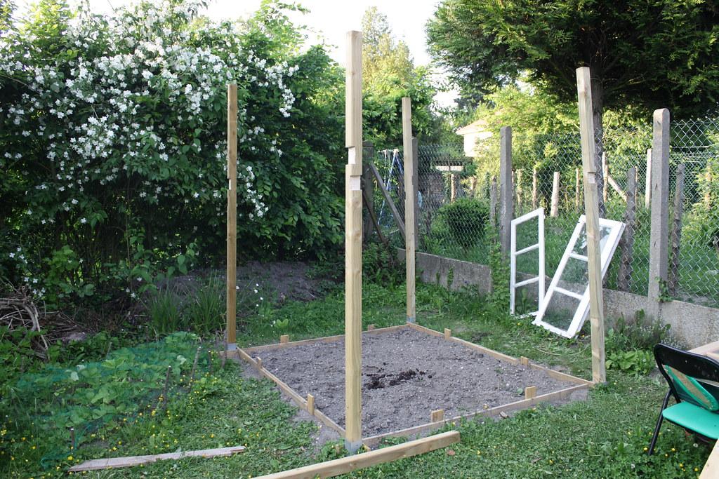 Use upcycled pallets to design a sustainable greenhouse-style pallet garden