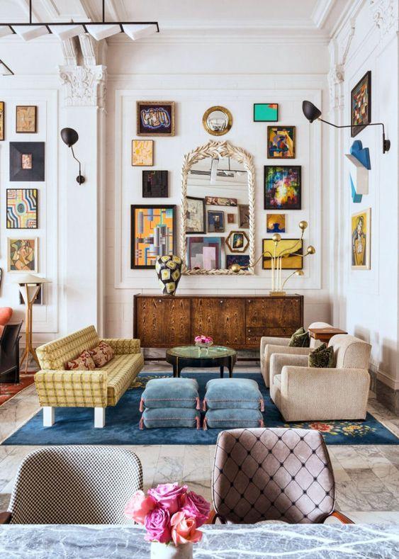 Hang a large mirror to amplify light in your eclectic living room space