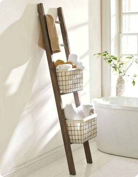 A​ vintage ladder offers stylish storage for farmhouse bathrooms