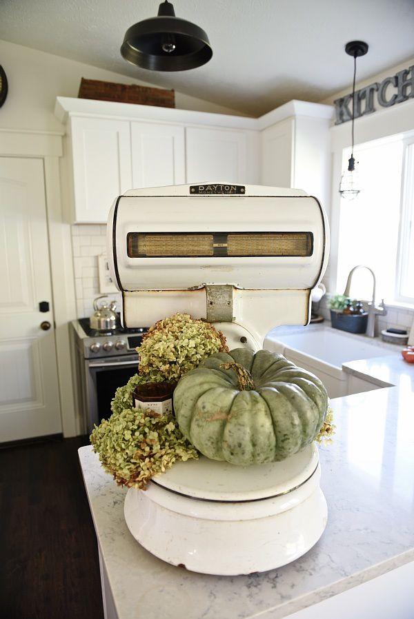 Vintage accessories, like old scales, add character to your farmhouse kitchen