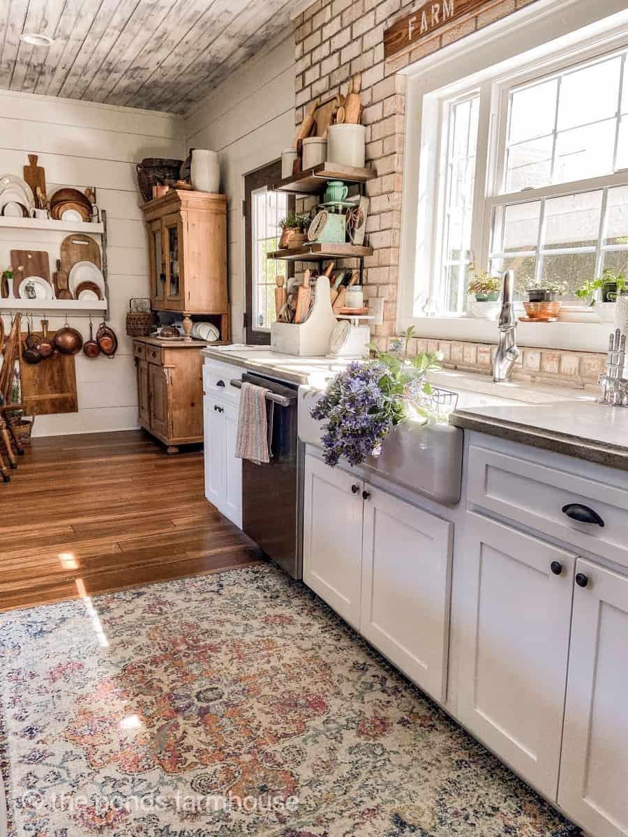 Well-worn hardwood floors exude a cozy ambiance in your farmhouse kitchen