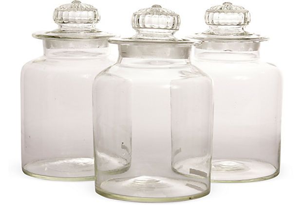 Unique trio of decorative glass jars with ornate lids .