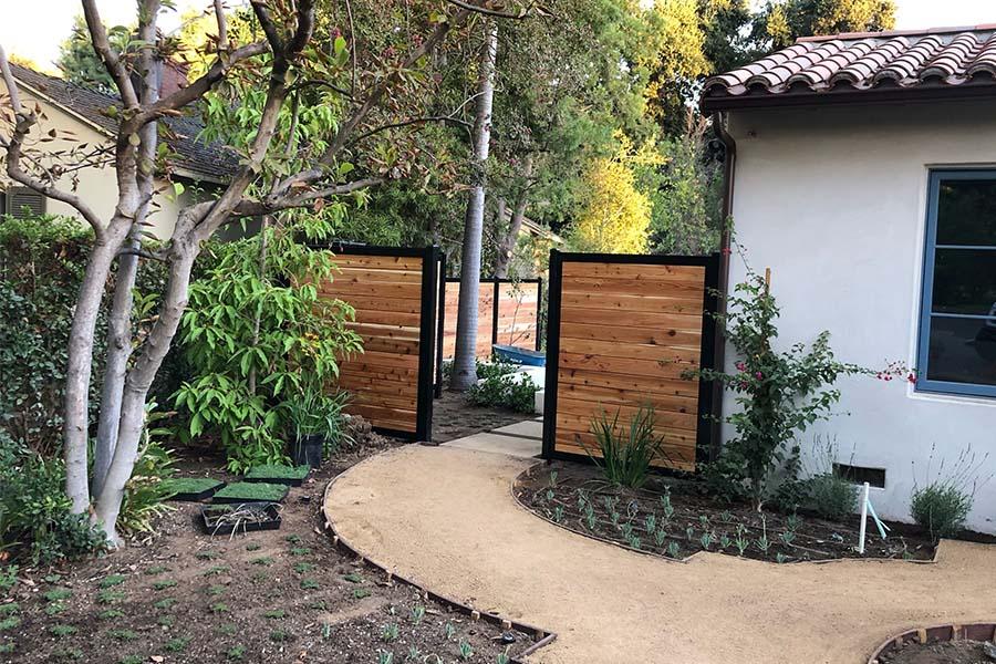 Add a decorative fence to enhance privacy in your front yard​ landscaping