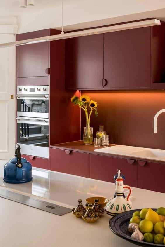 Use colorful accents to break the monochrome feel of‌ your‌ Burgundy Kitchen