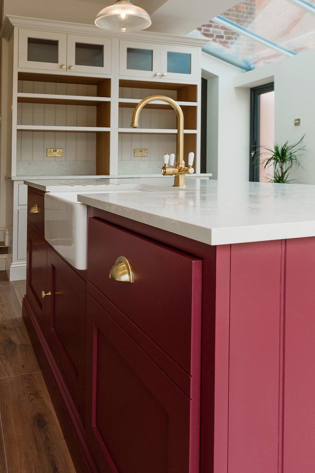 A farmhouse ​sink in burgundy kitchens adds charm and functionality